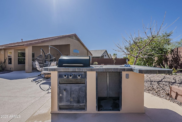 view of patio / terrace featuring exterior kitchen and fence