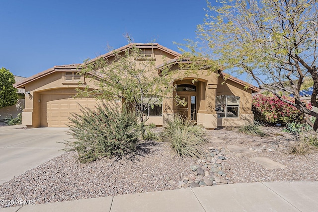 view of front of home featuring stucco siding, driveway, and a tiled roof