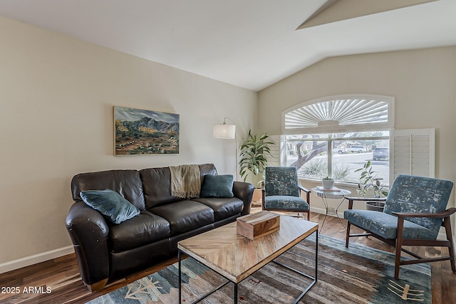 living room with lofted ceiling, wood finished floors, and baseboards