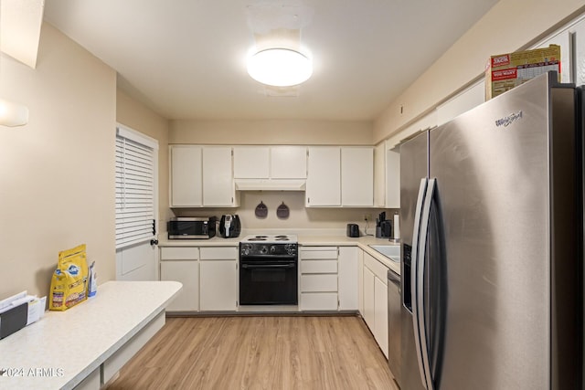 kitchen featuring white cabinets, light wood-type flooring, and appliances with stainless steel finishes