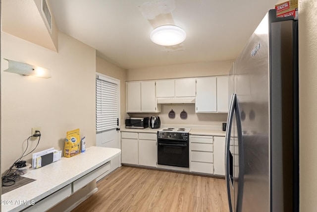 kitchen featuring white cabinets, light wood-type flooring, and appliances with stainless steel finishes