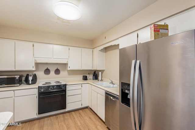 kitchen with white cabinets, light wood-type flooring, sink, and appliances with stainless steel finishes