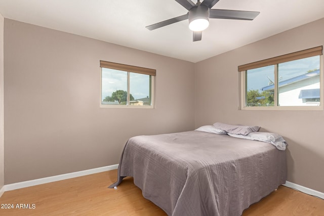 bedroom with light hardwood / wood-style floors and ceiling fan