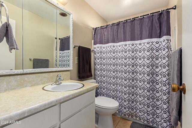 bathroom with tile patterned floors, vanity, curtained shower, and toilet