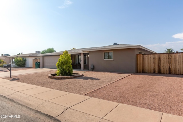 ranch-style home featuring a garage