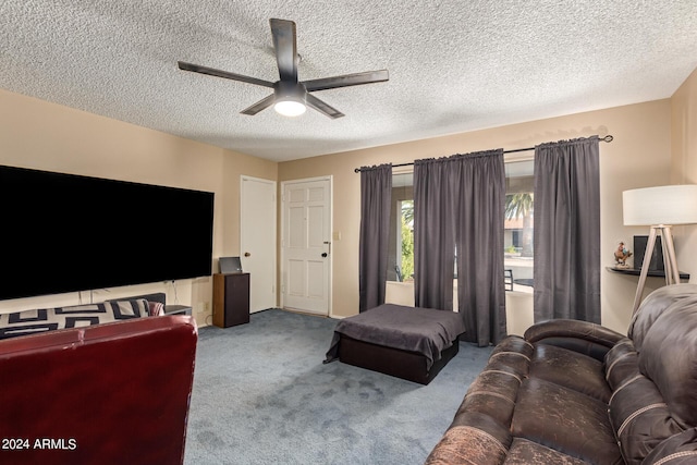 living room featuring ceiling fan, carpet floors, and a textured ceiling