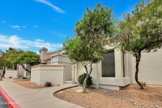1717 E Union Hills Dr Unit 1033, Phoenix, AZ 85024 - view of front of home featuring a gate, a fenced front yard, and stucco siding