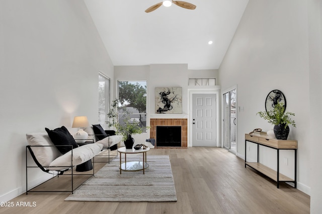 1717 E Union Hills Dr Unit 1033, Phoenix, AZ 85024 - living area featuring high vaulted ceiling, a ceiling fan, wood finished floors, baseboards, and a tiled fireplace