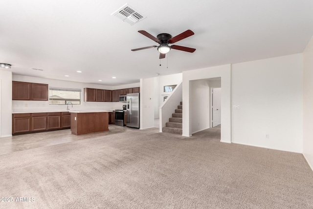 37911 N Luke Ln, San Tan Valley, AZ 85140 - unfurnished living room featuring a ceiling fan, a sink, stairs, light carpet, and recessed lighting