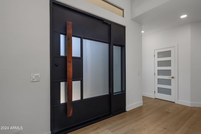 interior space featuring baseboards, light wood-style floors, and recessed lighting