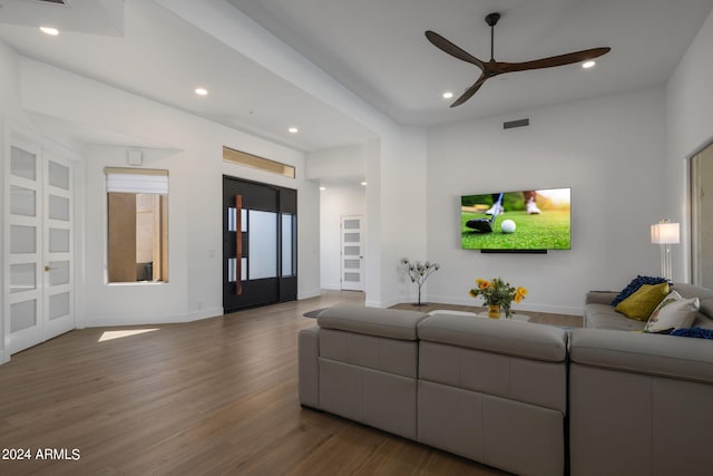 living room with visible vents, baseboards, wood finished floors, recessed lighting, and a ceiling fan
