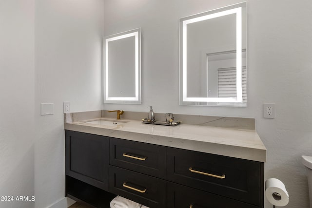 bathroom featuring toilet and vanity