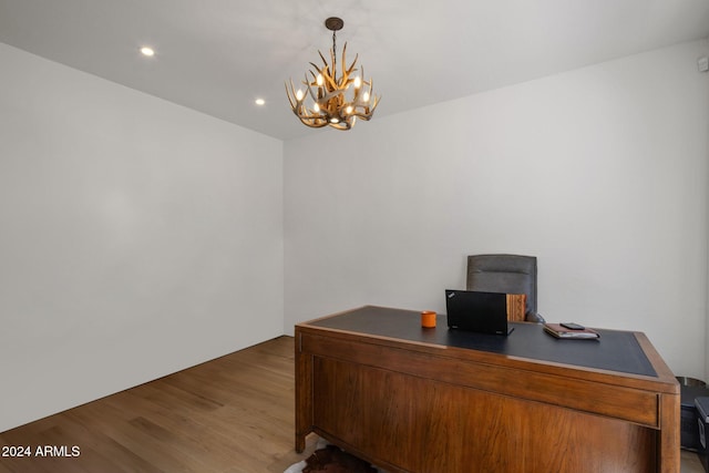 office space with wood finished floors, an inviting chandelier, and recessed lighting