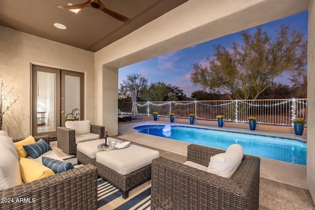 view of swimming pool featuring an outdoor living space, a patio area, a fenced in pool, fence, and ceiling fan