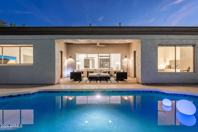 pool with a ceiling fan, an outdoor hangout area, and a patio area