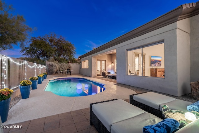 view of pool featuring a fenced backyard, an outdoor living space, a patio, and a fenced in pool