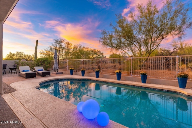 view of swimming pool with a fenced in pool, fence, and a patio area