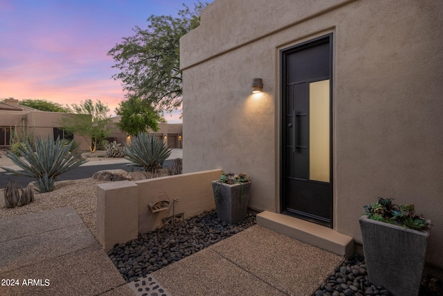 property entrance featuring stucco siding