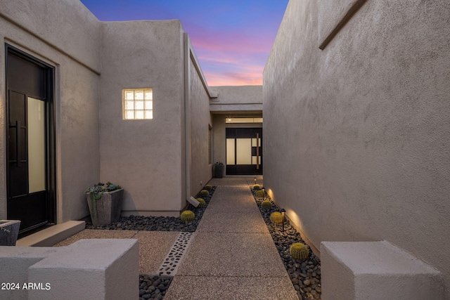 doorway to property featuring stucco siding