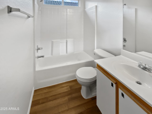 full bath with bathtub / shower combination, vanity, toilet, and wood finished floors