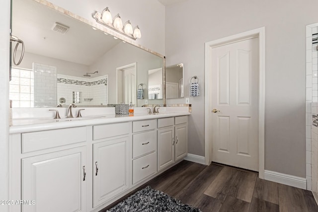 3580 E Kesler Ln, Gilbert, AZ 85295 - full bath featuring a sink, double vanity, baseboards, wood finished floors, and tiled shower