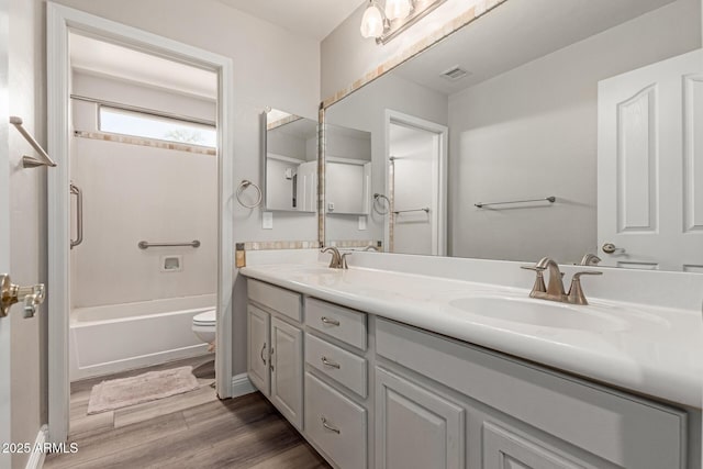 3580 E Kesler Ln, Gilbert, AZ 85295 - bathroom with a sink, double vanity, wood finished floors, and visible vents