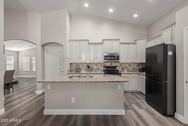 3580 E Kesler Ln, Gilbert, AZ 85295 - kitchen with light stone counters, a sink, a kitchen island with sink, and stainless steel appliances