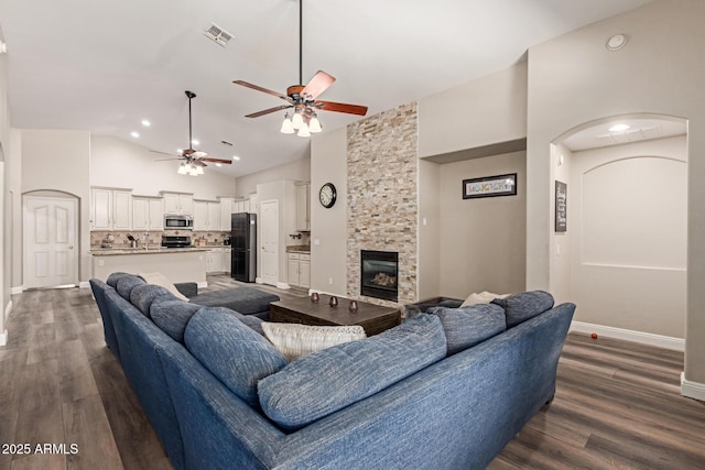 3580 E Kesler Ln, Gilbert, AZ 85295 - living area featuring ceiling fan, a fireplace, dark wood-type flooring, and visible vents