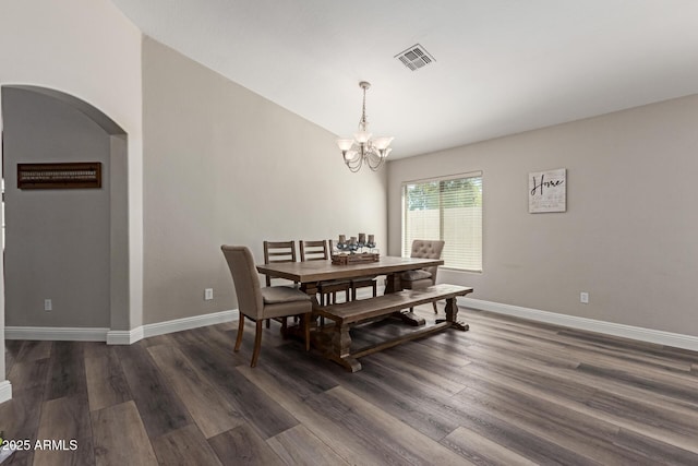 3580 E Kesler Ln, Gilbert, AZ 85295 - dining area featuring dark wood-style flooring, arched walkways, a notable chandelier, and visible vents