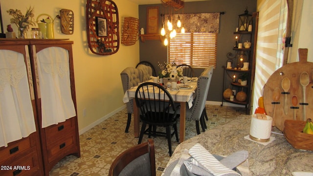 dining room with a chandelier and light tile patterned flooring