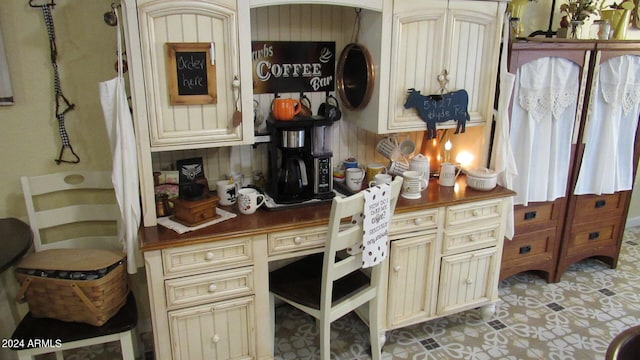 kitchen with cream cabinets and light tile patterned flooring