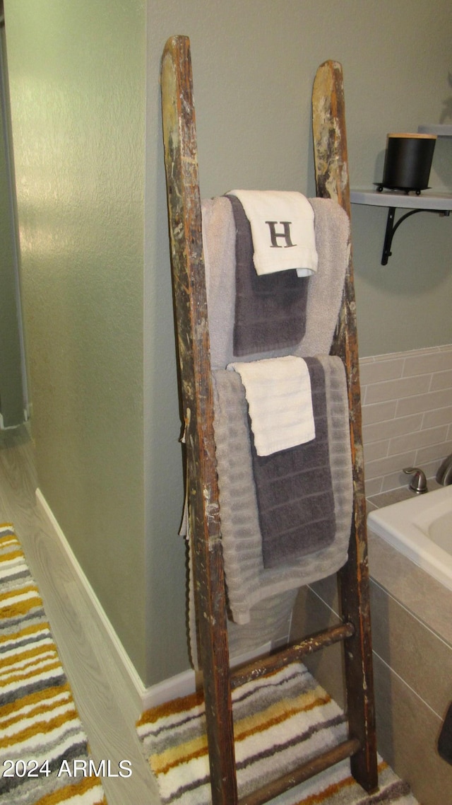 bathroom featuring a relaxing tiled tub