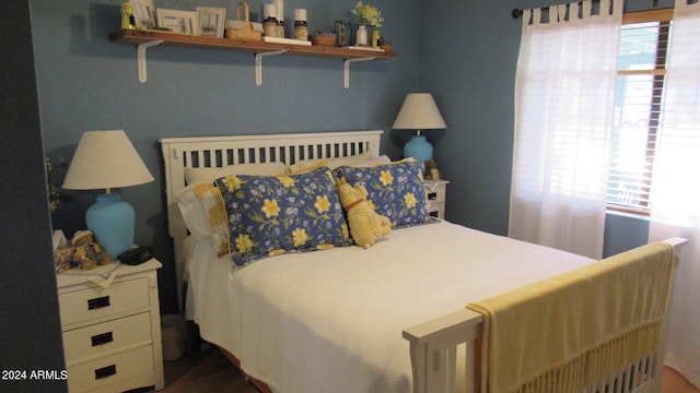 bedroom featuring dark wood-type flooring and multiple windows