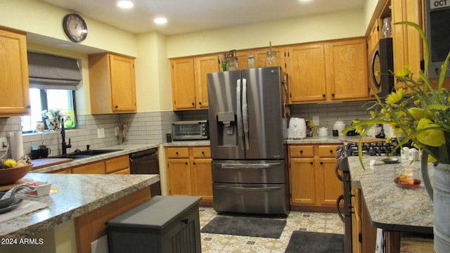 kitchen featuring tasteful backsplash, stainless steel fridge, sink, and dishwasher