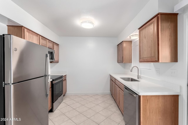 kitchen featuring sink, light tile patterned floors, and stainless steel appliances