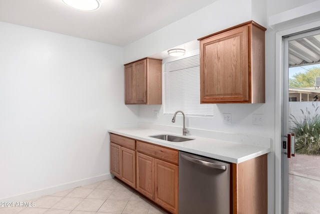 kitchen featuring dishwasher, light tile patterned floors, and sink