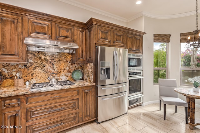 kitchen featuring appliances with stainless steel finishes, backsplash, exhaust hood, and light stone counters