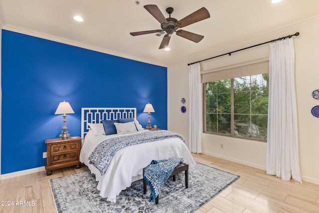 bedroom with ceiling fan, light wood-type flooring, and crown molding