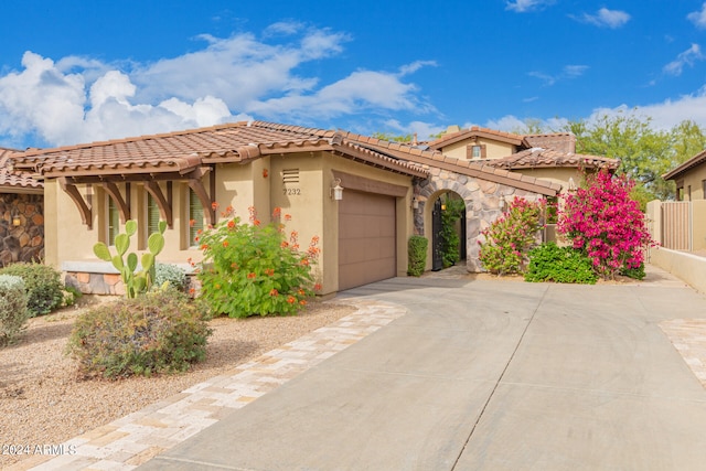 mediterranean / spanish home with a garage