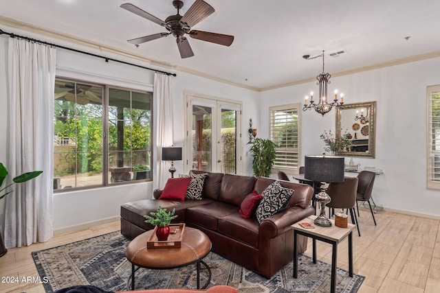 living room with ceiling fan with notable chandelier and ornamental molding