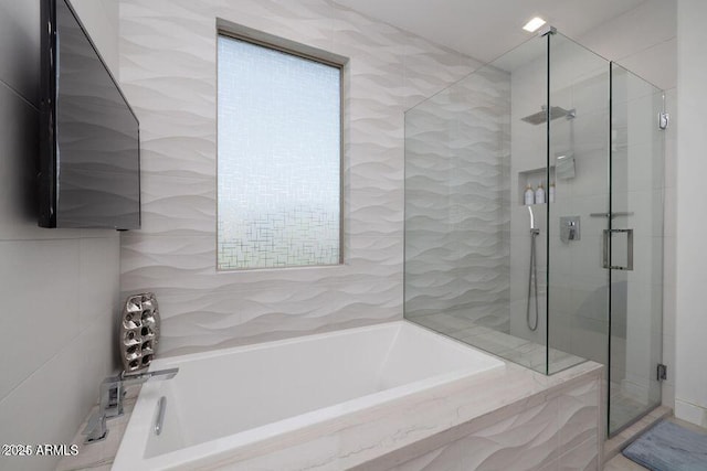 bathroom with a garden tub and a stall shower