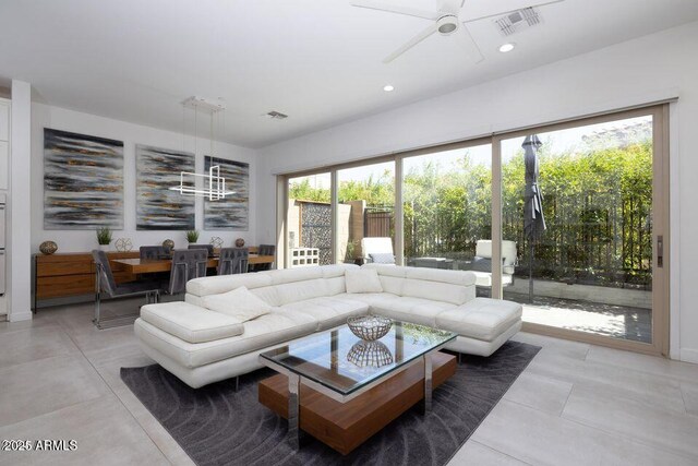 living area with recessed lighting, visible vents, and ceiling fan with notable chandelier