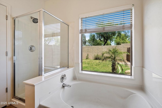 full bath featuring a garden tub and a shower stall