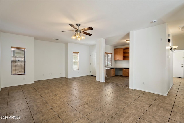 unfurnished living room featuring baseboards, ceiling fan, visible vents, and light tile patterned floors