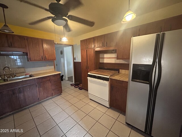 3021 E Saint John Rd, Phoenix, AZ 85032 - kitchen featuring white gas stove, a sink, decorative backsplash, light countertops, and stainless steel refrigerator with ice dispenser