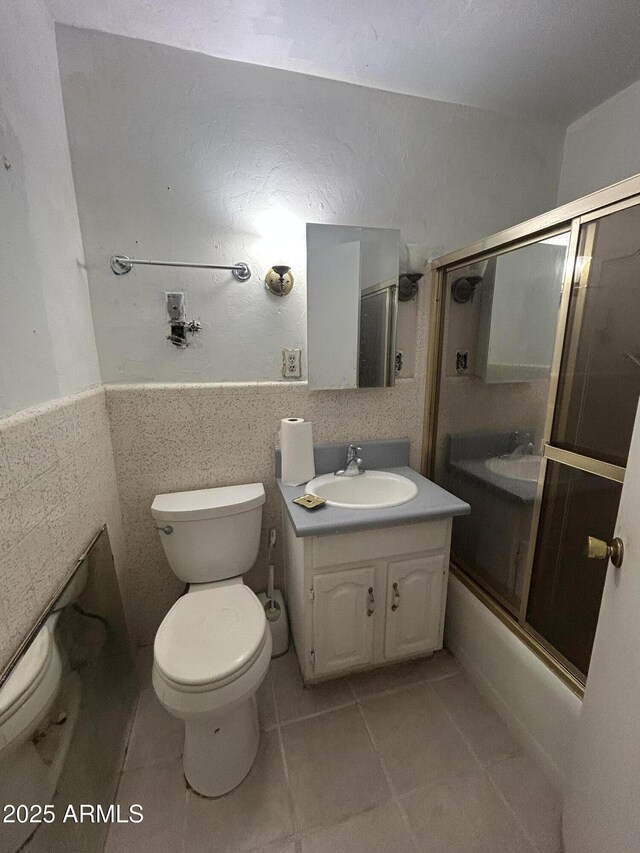 3021 E Saint John Rd, Phoenix, AZ 85032 - full bathroom with vanity, tile patterned flooring, bath / shower combo with glass door, and toilet
