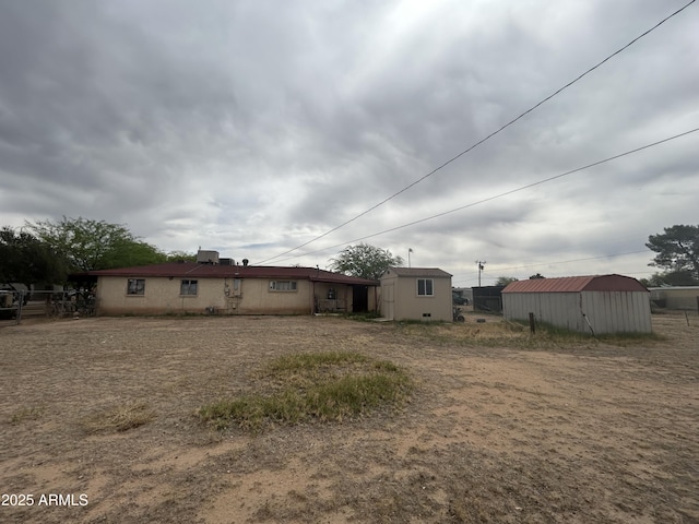 3021 E Saint John Rd, Phoenix, AZ 85032 - rear view of property with an outdoor structure and a storage unit