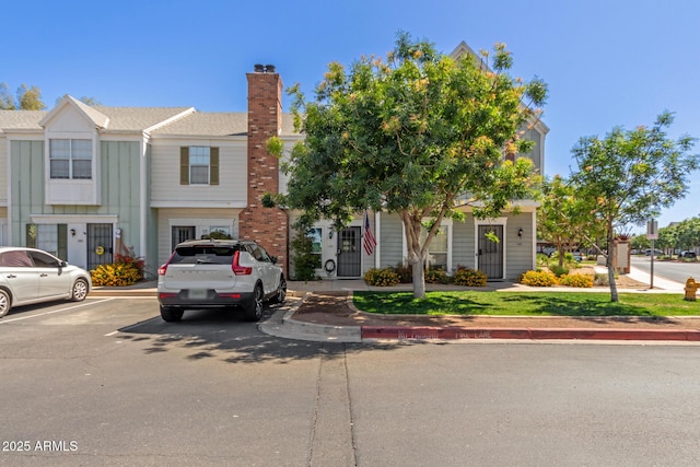 1600 N Saba St Unit 143, Chandler, AZ 85225 - view of property featuring uncovered parking and a chimney