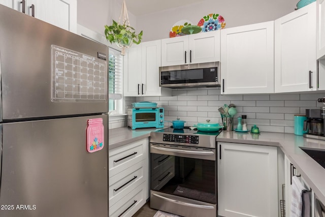 1600 N Saba St Unit 143, Chandler, AZ 85225 - kitchen with appliances with stainless steel finishes, light countertops, tasteful backsplash, and white cabinets