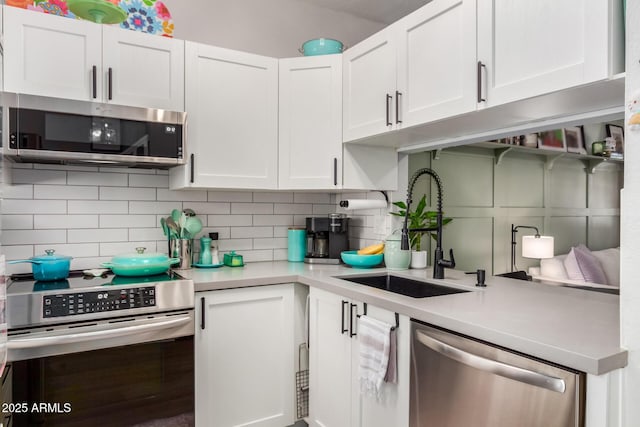 1600 N Saba St Unit 143, Chandler, AZ 85225 - kitchen featuring stainless steel appliances, a sink, light countertops, and white cabinets